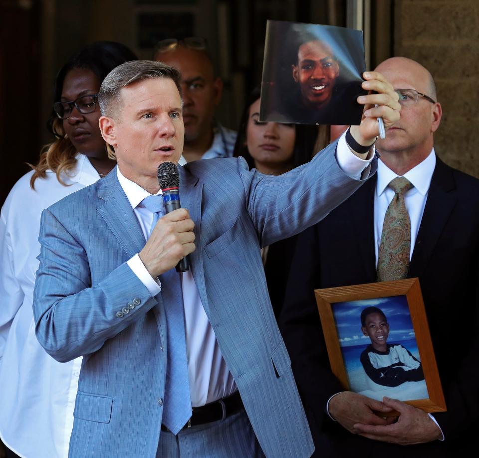 Attorney Bobby DiCello holds up a photograph of Jayland Walker, 25, as he speaks on behalf of the Walker family during a news conference on June 30, 2022, in Akron, Ohio.