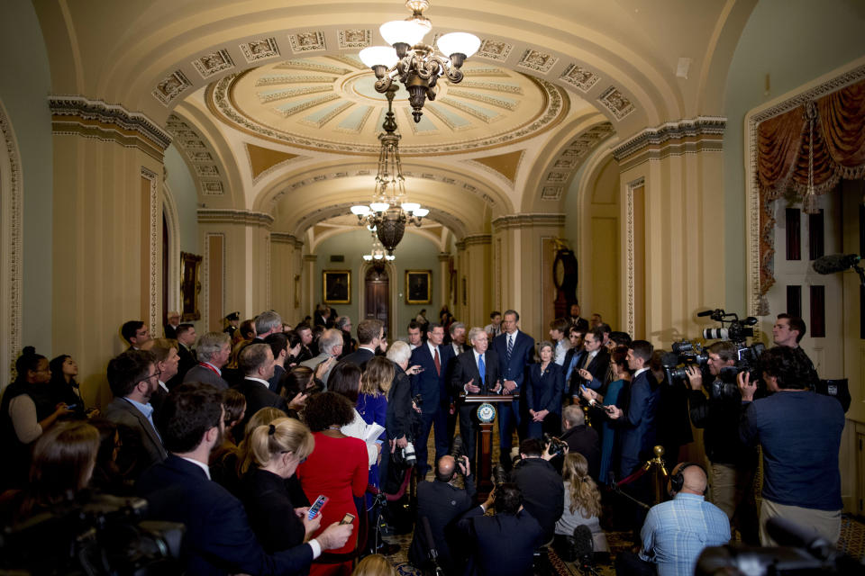 FILE - In this Tuesday, Dec. 10, 2019, file photo, Senate Majority Leader Mitch McConnell, R-Ky., accompanied by from left, Sen. Todd Young, R-Ind., Sen. John Barrasso, R-Wyo., Sen. Roy Blunt, R-Mo., Senate Majority Whip Sen. John Thune, R-S.D., and Sen. Joni Ernst, R-Iowa, speaks to reporters during a news conference, on Capitol Hill in Washington. Reporters at the Capitol want more cameras in the Senate to cover the impeachment trial and fewer restrictions to talk to senators when they are not sitting in judgment of the president. (AP Photo/Andrew Harnik, File)