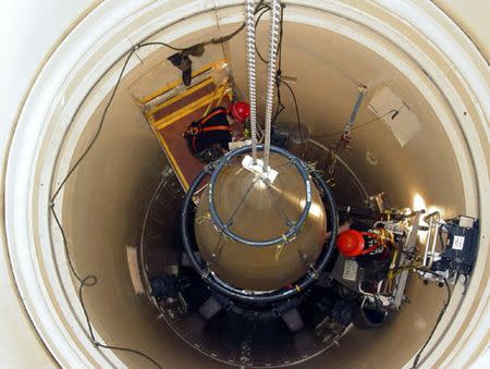 FILE PHOTO: A US Air Force missile maintenance team removes the upper section of an intercontinental ballistic missile with a nuclear warhead in an undated USAF photo at Malmstrom Air Force Base, Montana. REUTERS/USAF/Airman John Parie/handout via Reuters