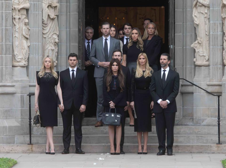 Former President Donald Trump's children and their spouses wait in the doorway of the Church of Bethesda-by-the-Sea following the funeral for Melania Trump's mother, Amalija Knavs, on Thursday.