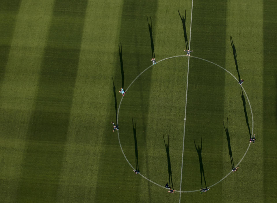 In this Nov. 1, 2018 photo, Argentina's national female soccer team poses for a photo at the Argentina Football Association, after a training session in Buenos Aires, Argentina. The team only was given access to the men's training ground after its poor working conditions became publicly known.(AP Photo/Natacha Pisarenko)