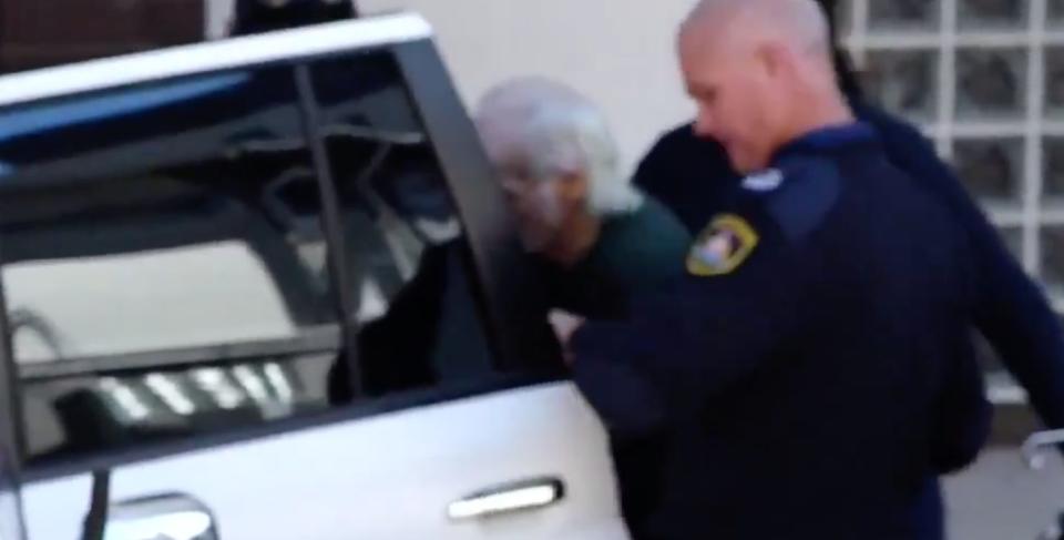 Ivan Milat pictured getting into a car to be taken back to hospital.