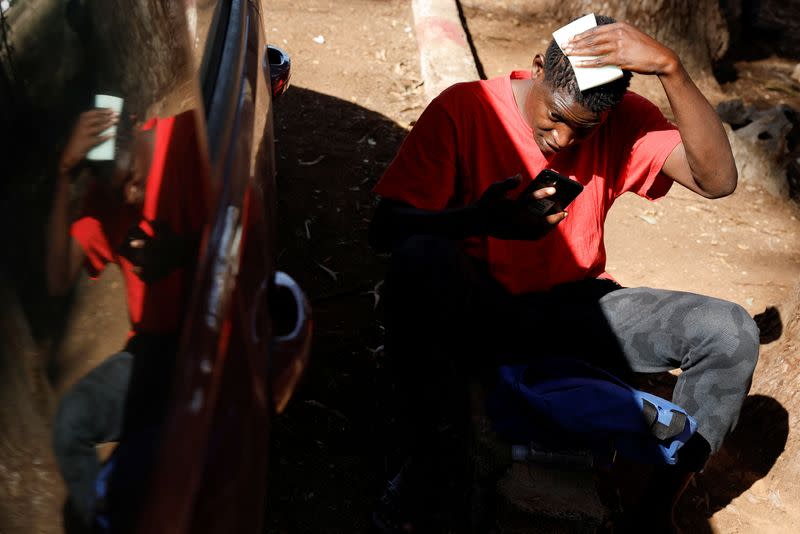 Ndoye, a 16-year-old migrant from Senegal, cleans his head outside of Las Raices migrant camp on the island of Tenerife