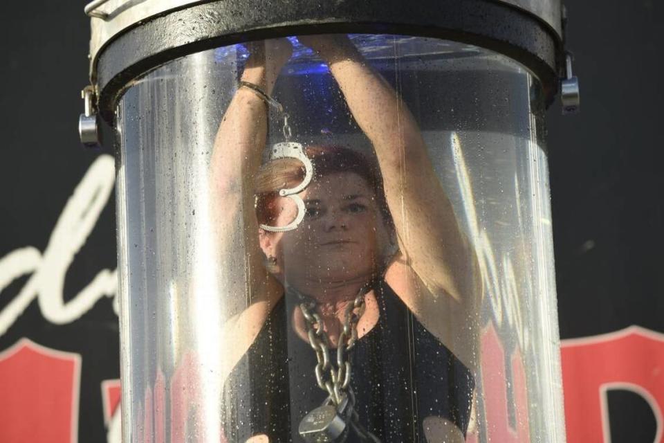 Escape artist Kristen Johnson, who performs under the name “Lady Houdini,” performed at the Lion’s Club Bluegrass Fair July 14 to 28, 2016 in Masterson Station Park in Lexington, Ky. Here, she works to escape the water torture chamber, a feat she has accomplished more than 1,700 times.