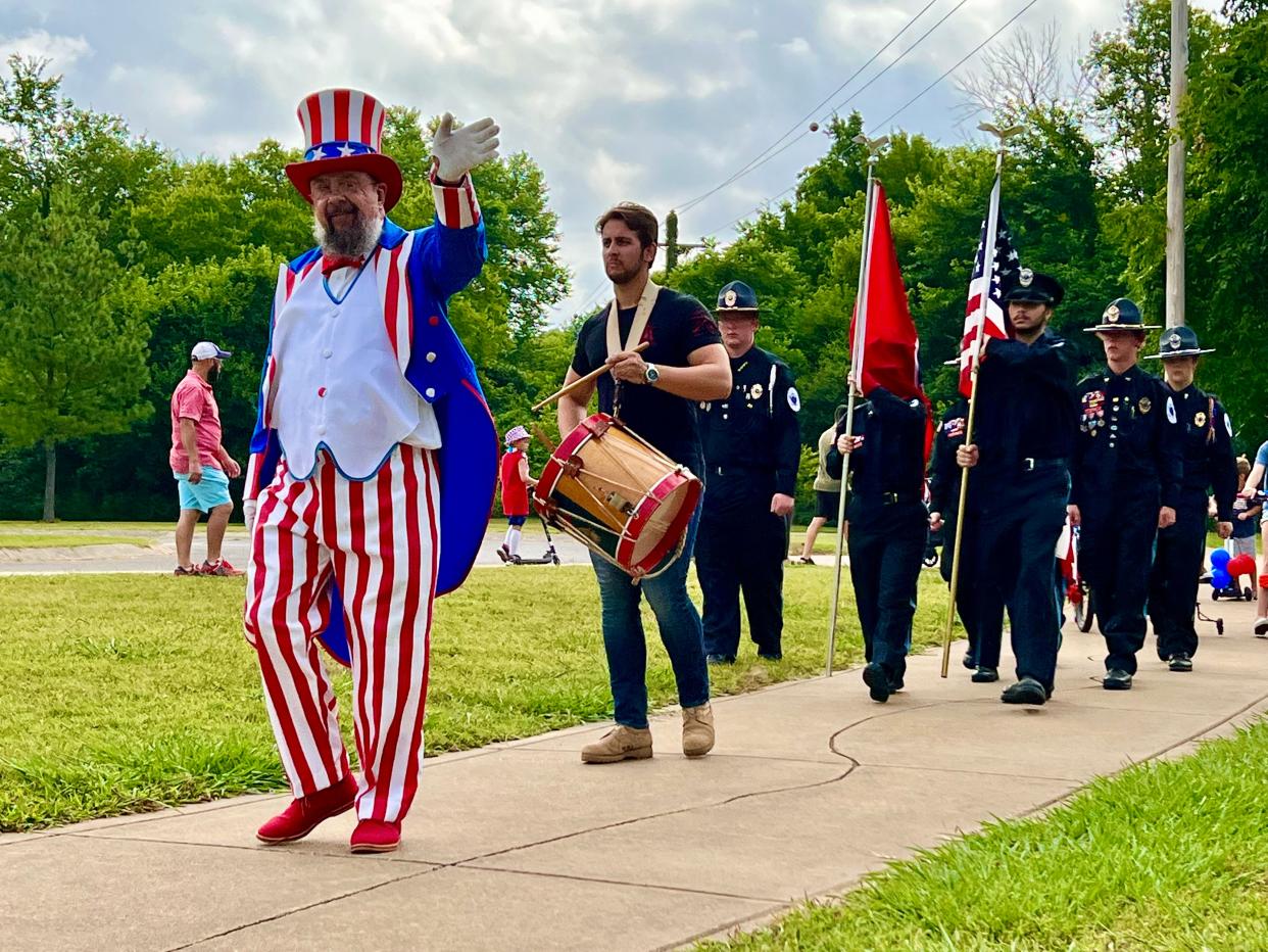 Eric Previti as Uncle Sam leads the annual Riverwalk bike and wagon parade on Monday, July 4, 2022.