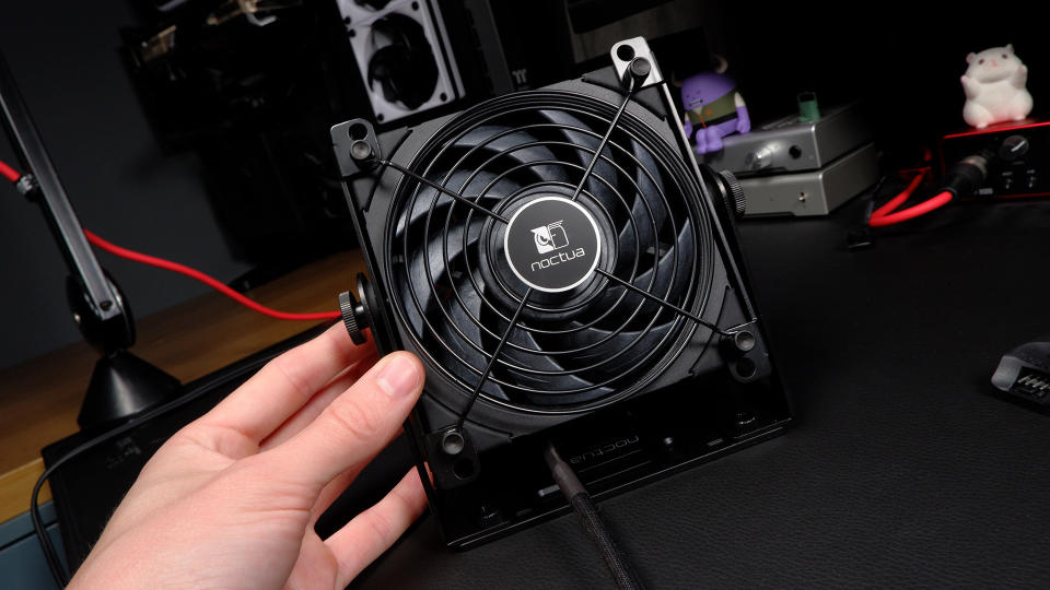 Noctua's NV-FS1 desk fan on a black desk.