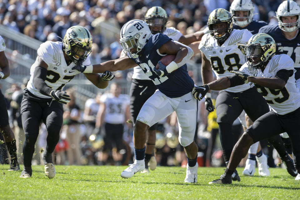 Penn State running back Noah Cain (21) stiff arms Purdue safety Navon Mosley (27) in the fourth quarter of an NCAA college football game in State College, Pa., on Saturday, Oct. 5, 2019. Penn State defeated Purdue 35-7. (AP Photo/Barry Reeger)