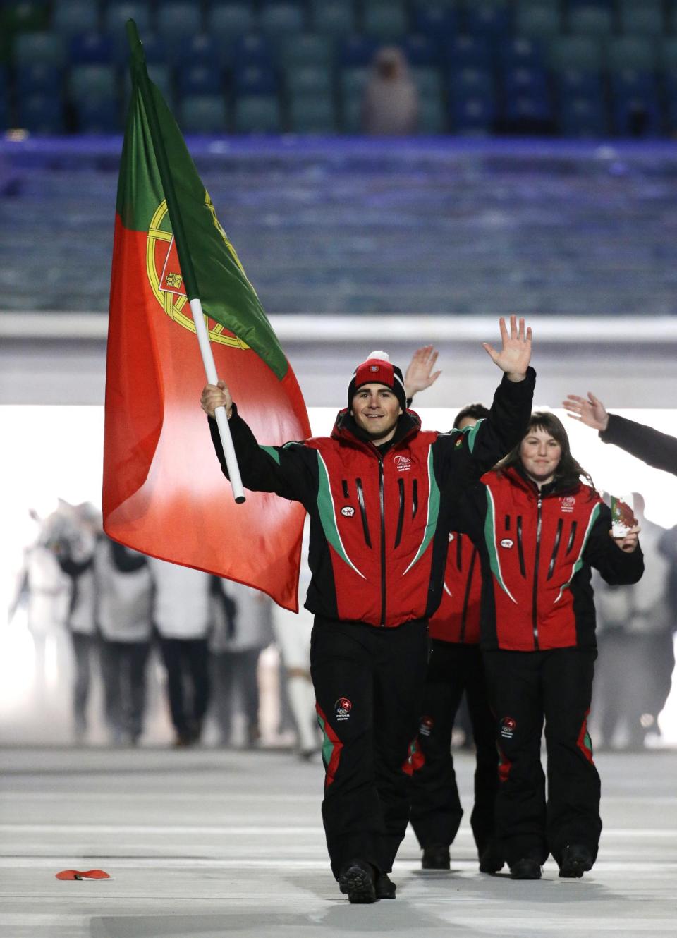 Arthur Hanse of Portugal carries the national flag as he leads the team during the opening ceremony of the 2014 Winter Olympics in Sochi, Russia, Friday, Feb. 7, 2014. (AP Photo/Mark Humphrey)