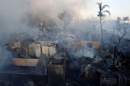 Destroyed houses are seen during a fire at a residential neighbourhood in Las Pinas, Metro Manila, Philippines, March 14, 2018. REUTERS/Erik De Castro