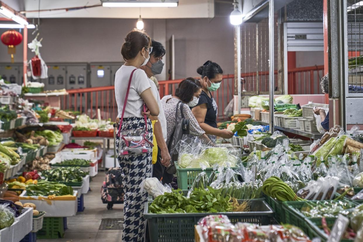 Shoppers choose vegetables at Chinatown Food Complex and Market in Singapore, on Thursday, Feb. 17, 2022. 