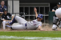 Texas Rangers' Brad Miller scores on a two-run double by Marcus Semien during the 10th inning of a baseball game against the Chicago White Sox in Chicago, Saturday, June 11, 2022. (AP Photo/Nam Y. Huh)