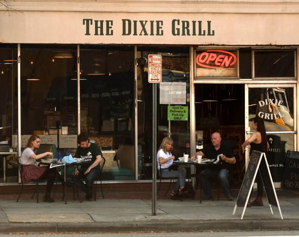Customers eat lunch outside of The Dixie Grill that has been opened in downtown Wilmington since 1903. KEN BLEVINS/STARNEWS
