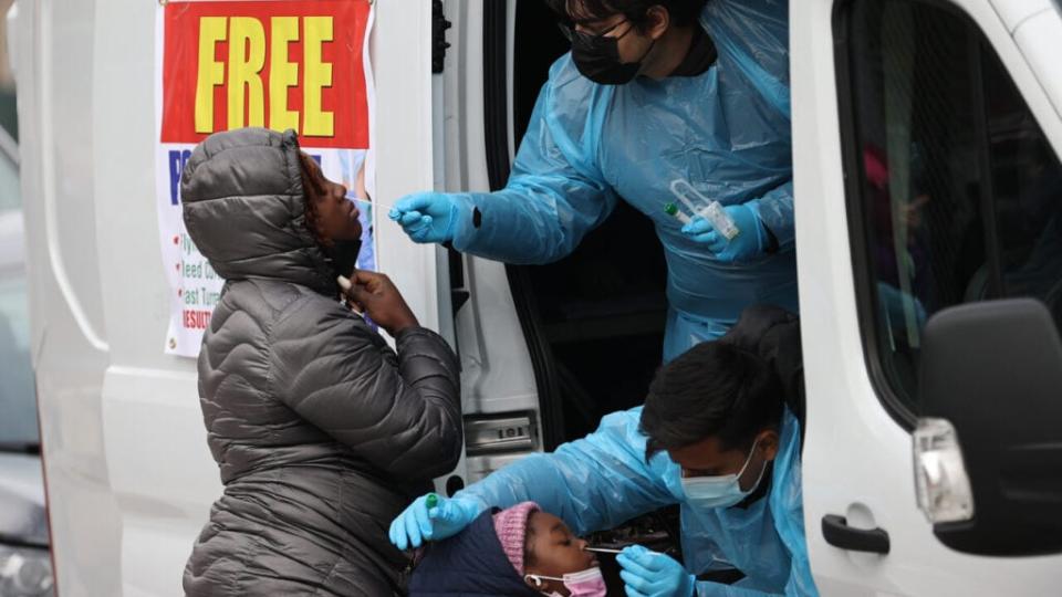 A woman and her kid are getting a Covid-19 test at a Covid-19 testing center next to the Queens Hospital Center as hundreds of residents line up to get Covid-19 test in Queens of New York, United States on December 28, 2021 as Omicron rises around the country. (Photo by Tayfun Coskun/Anadolu Agency via Getty Images)