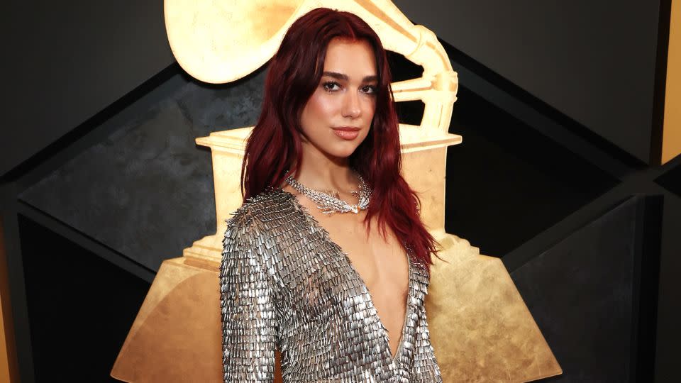 Dua Lipa arrived in a chainmail-style custom Courrèges gown with small cut-outs at the hip. “I feel a bit (of) Joan of Arc energy in it,” she said during the official red carpet pre-show. The singer completed the look with Tiffany & Co jewelry, including a stunning necklace featuring rubellites, diamonds and an orange sapphire. - Kevin Mazur/Getty Images