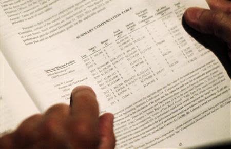 Shareholder activist John Chevedden, 67, looks over executive pay charts as he waits for the DreamWorks Animation SKG Inc stockholder meeting to begin in Hollywood, California May 29, 2013. icture taken May 29, 2013. For use with special report ACTIVIST-CHEVEDDEN/ REUTERS/Lucy Nicholson