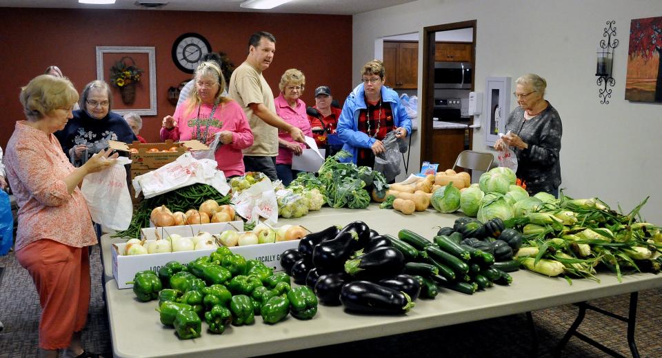 Residents at OrrVilla Evergreen Place pick out fresh vegetables to take home for meals. A Whole Community delivers farm produce to food pantries, free meal sites, senior communities, low income neighborhoods and other sites throughout the Wayne County.