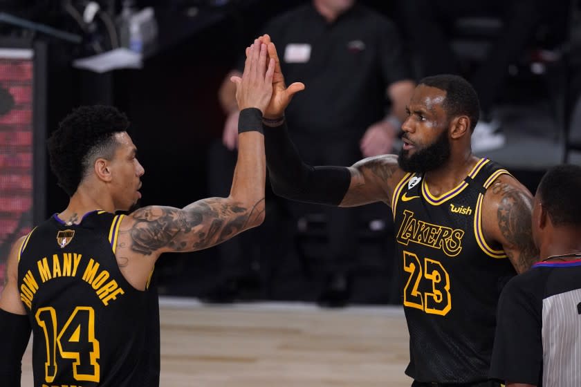 Los Angeles Lakers' Danny Green (14) and LeBron James (23) celebrate a basket by James.