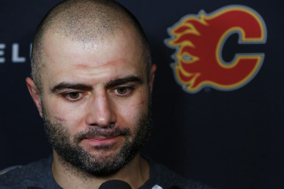 Calgary Flames Mark Giordano addresses the media following NHL hockey practice Tuesday, Nov. 26, 2019, in Buffalo, N.Y. Flames general manager Brad Treliving says coach Bill Peters remains on the staff but wasn’t certain whether he’d be behind the bench for the next game. The team and the NHL are both investigating an allegation the Peters directed racial slurs at a player 10 years ago when the two were in the minors. Akim Aliu, a Nigerian-born player, says Peters “dropped the N bomb several times” in a dressing room during his rookie year. (AP Photo/Jeffrey T. Barnes)