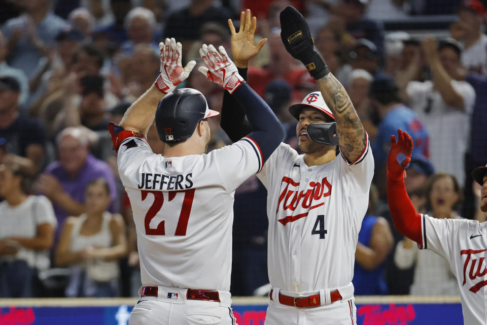 Minnesota Twins' Ryan Jeffers (27) celebrates with Carlos Correa (4) after hitting a two-run home run against the Texas Rangers in the eighth inning of a baseball game Thursday, Aug. 24, 2023, in Minneapolis. (AP Photo/Bruce Kluckhohn)