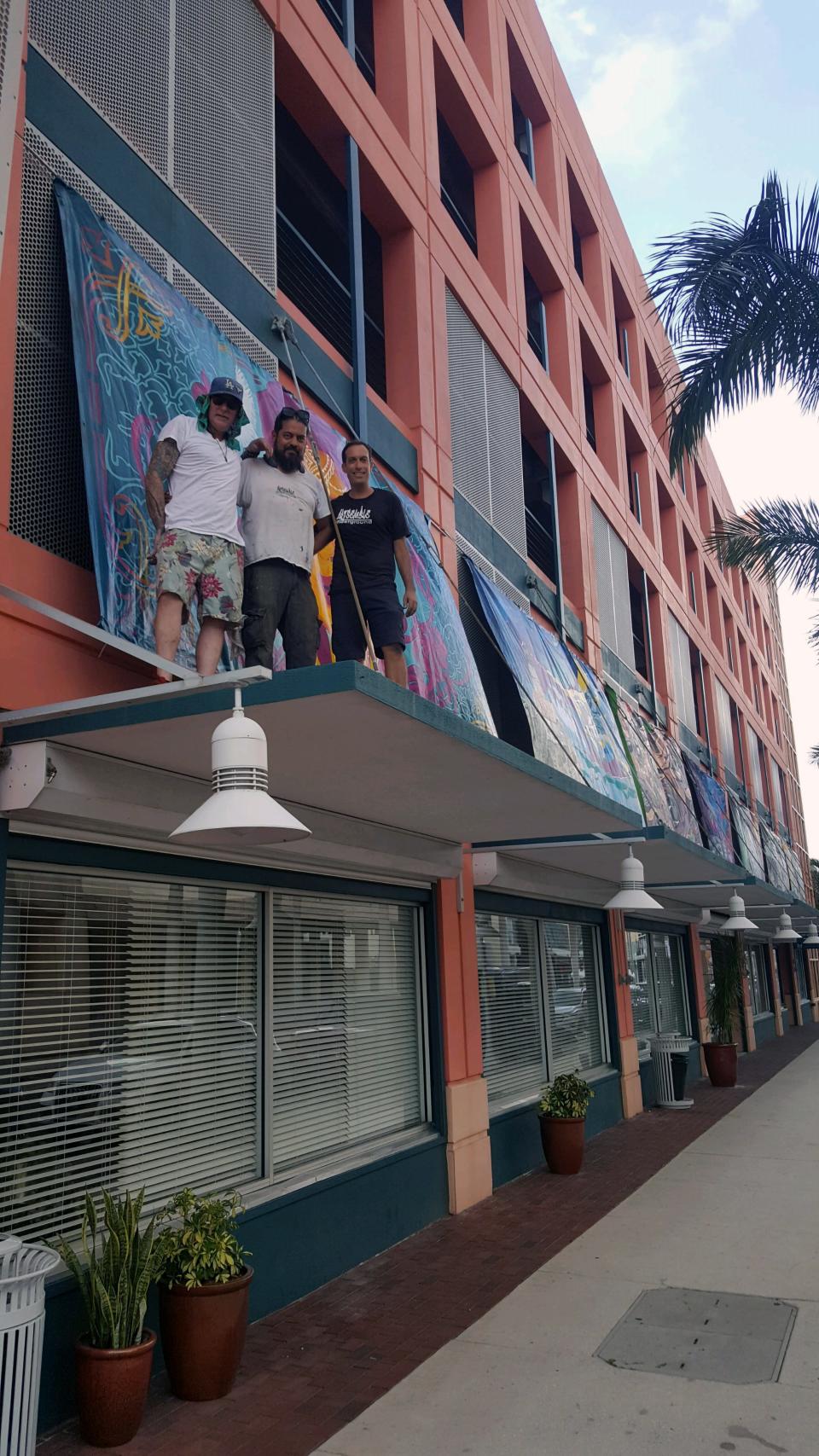 Artists pose from the 2023 SWFL Mural Fest in downtown Fort Myers