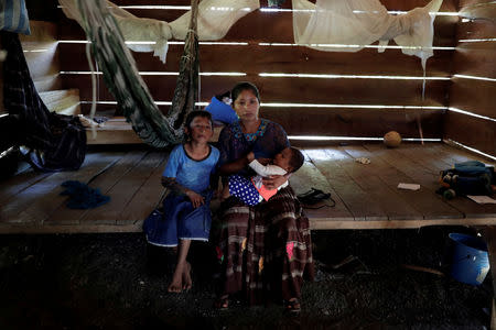 FILE PHOTO: Claudia Maribel Maquin, mother of Jakelin, a 7-year-old girl who died in U.S. custody, poses for a picture with her children inside her house in San Antonio Secortez, municipality of Raxruha, Guatemala December 19, 2018. REUTERS/Luis Echeverria/File Photo