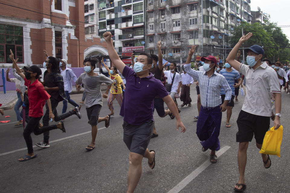 Anti-coup protesters display the three-finger sign of resistance during a flash mob on Thursday, June 3, 2021, in Yangon, Myanmar. Resistance to military rule remains widespread four months after civilian leader Aung San Suu Kyi was removed from power on Feb. 1, 2021. (AP Photo)