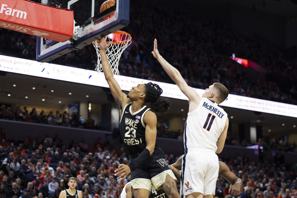 Wake Forest's Hunter Sallis (23) shoots past Virginia's Isaac McKneely (11) during the first half of an NCAA college basketball game Saturday, Feb. 17, 2024 in Charlottesville, Va. (AP Photo/Mike Kropf)