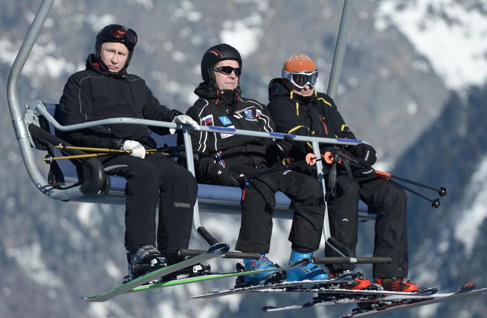 Russian President Vladimir Putin (L) and Prime Minister Dmitry Medvedev (C) sit on a chair lift during their visit to the "Laura" cross country ski and biathlon centre in the resort of Krasnaya Polyana near Sochi January 3, 2014. REUTERS/Alexei Nikolskiy/RIA Novosti/Kremlin (RUSSIA - Tags: POLITICS SPORT OLYMPICS) ATTENTION EDITORS - THIS IMAGE HAS BEEN SUPPLIED BY A THIRD PARTY. IT IS DISTRIBUTED, EXACTLY AS RECEIVED BY REUTERS, AS A SERVICE TO CLIENTS