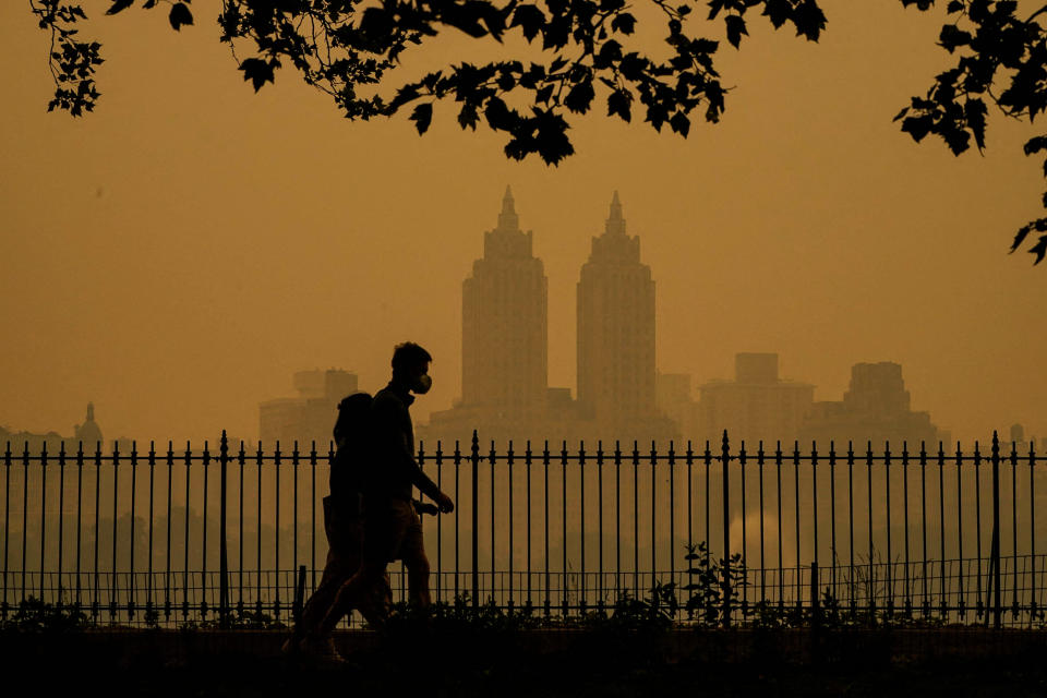 Image: People walk in Central Park as smoke from wildfires in Canada cause hazy conditions in New York on June 7, 2023. (Timothy A. Clary / AFP - Getty Images)