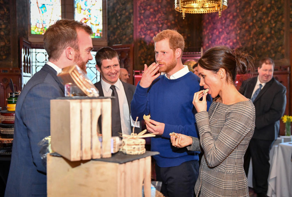 Prince Harry and Meghan Markle sample traditional Welsh cakes during a visit to Cardiff Castle on Jan. 18 in Wales. (Photo: WPA Pool via Getty Images)