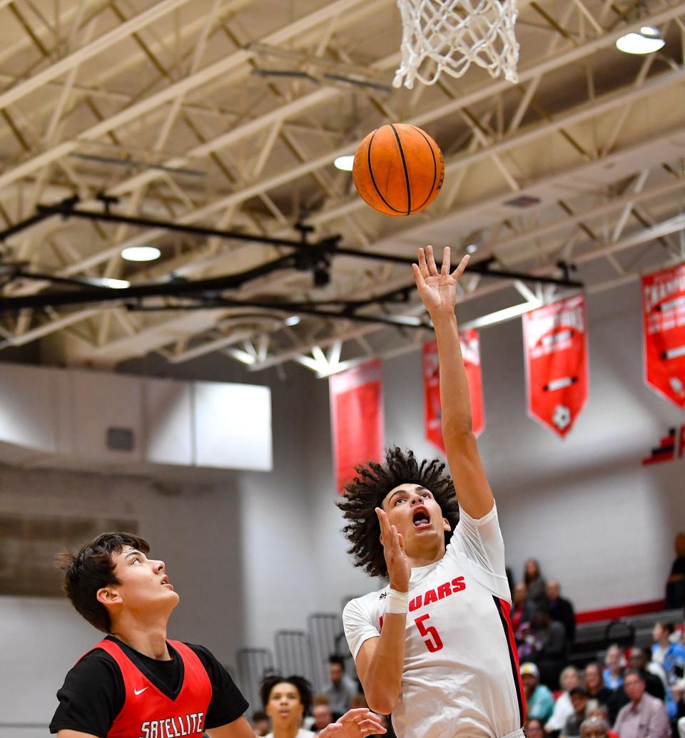 Port St. Lucie’s Ryan Rodriguez (5) hits a layup in a boys high school district 13-5A quarterfinal, Thursday, Feb. 8, 2024, in Port St. Lucie.