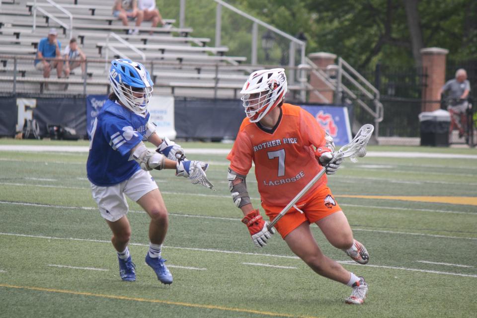 Gaining control of the ball, Bloomfield Hills Brother Rice's Johnny Kunz tries to get around Novi Detroit Catholic Central's Matt Aleva. Brother Rice won the battle of the two Catholic League schools, 14-11, to win the Division 1 lacrosse state title in East Grand Rapids on Saturday, June 10, 2023.