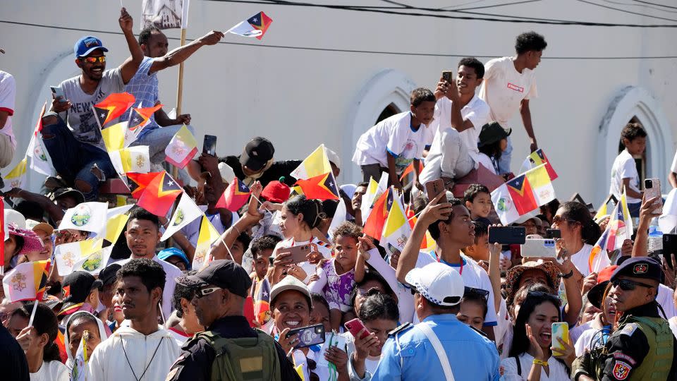 People wait for Pope Francis to arrive at the Cathedral of the Immaculate Conception in Dili, East Timor, on September 10, 2024. - Firdia Lisnawati/AP