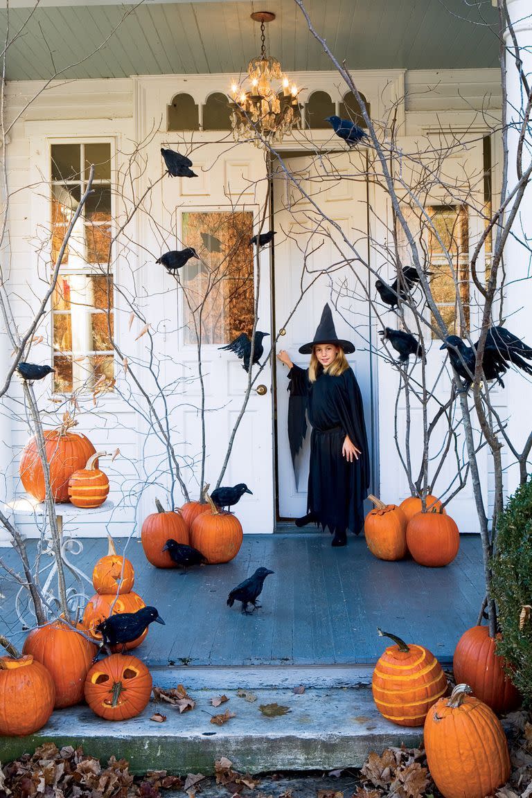 <p>If your front yard doesn't have any trees to hang ornaments from, create some by planting tall branches into pumpkins. Don't forget to add fake crows to spook your visitors. </p><p><a class="link " href="https://www.amazon.com/Halloween-Realistic-Handmade-Feathered-Decoration/dp/B075K5FQNL/?tag=syn-yahoo-20&ascsubtag=%5Bartid%7C10055.g.4602%5Bsrc%7Cyahoo-us" rel="nofollow noopener" target="_blank" data-ylk="slk:SHOP CROW DECORATIONS;elm:context_link;itc:0;sec:content-canvas">SHOP CROW DECORATIONS</a></p>