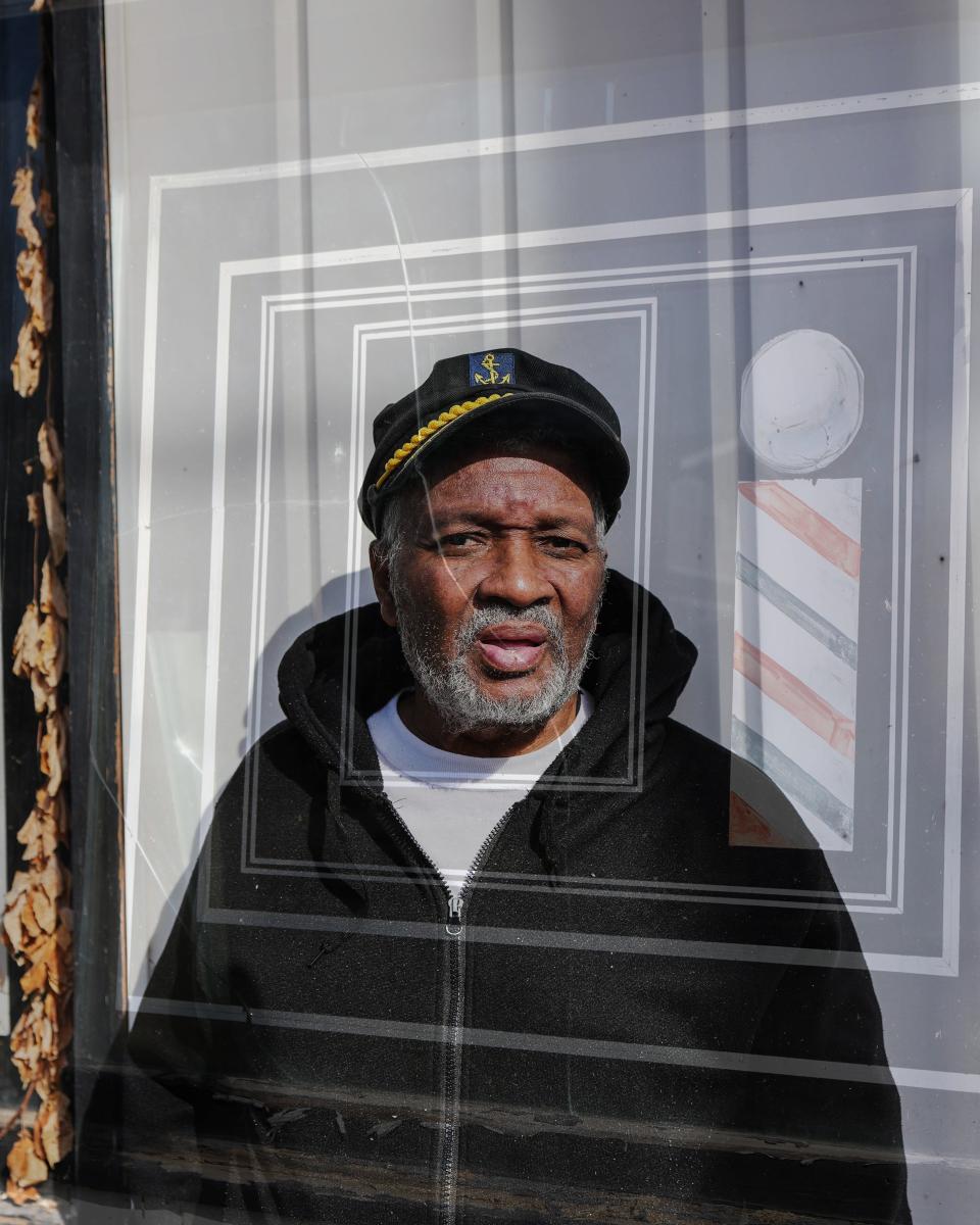 A double exposure of the barber's pole in the window of Harlan's Barber Shop, 2513 Woodland Ave., with former owner Harlan Thomas on Friday, March 3, 2023.