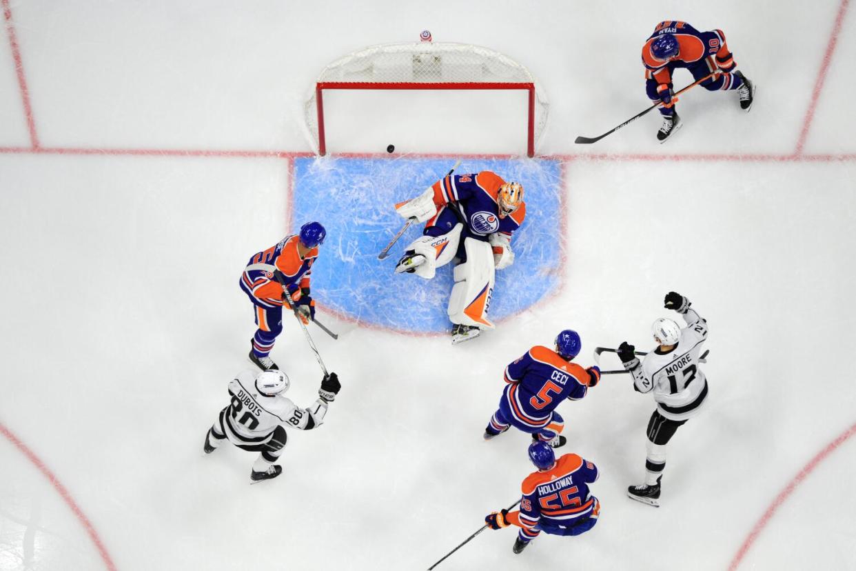 Trevor Moore, right, scores past Edmonton Oilers goaltender Stuart Skinner during a game on Feb. 26.