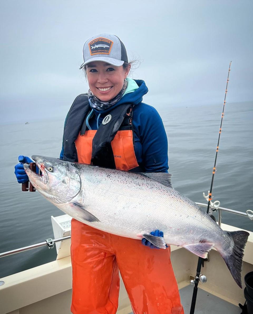 Capt. Virginia Salvador of Gatecrasher Fishing Adventures shows off a huge king salmon caught during a trolling adventure off the Marin County coast on June 27.