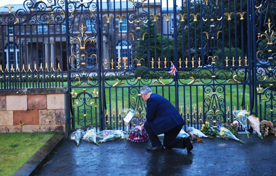 DUP leader Jeffrey Donaldson looks at floral tributes at Hillsborough Castle (Peter Morrison/PA) (PA Wire)