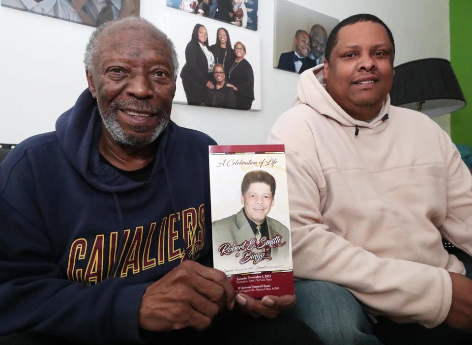 George McClain holds a the Celebration of Life program with a photo of Robert "Bingo" Smith with Smith's son Andre, 48, Jan. 4 in Akron. McClain was close friends with Cavaliers legend Bingo Smith and drove him to team appearances for years.