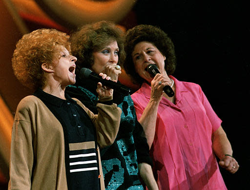 Country music legends Brenda Lee, Loretta Lynn, and Kitty Wells, from left, rehearse a song in preparation for the annual Country Music Association awards show in Nashville, Tenn., on October 10, 1988. (AP Photo/Mark Humphrey)