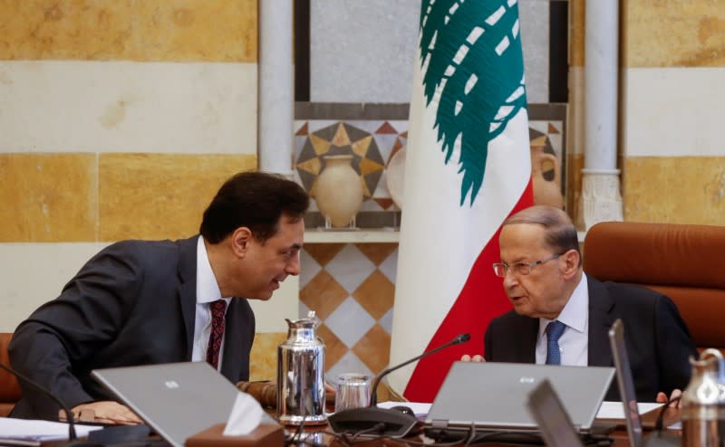 FILE PHOTO: Lebanon's Prime Minister Hassan Diab speaks with Lebanon's President Michel Aoun during a cabinet meeting at the presidential palace in Baabda