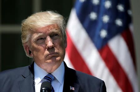 U.S. President Donald Trump listens as South Korean President Moon Jae-in delivers a statement from the Rose Garden after meetings at the White House in Washington, U.S. June 30, 2017. REUTERS/Jim Bourg