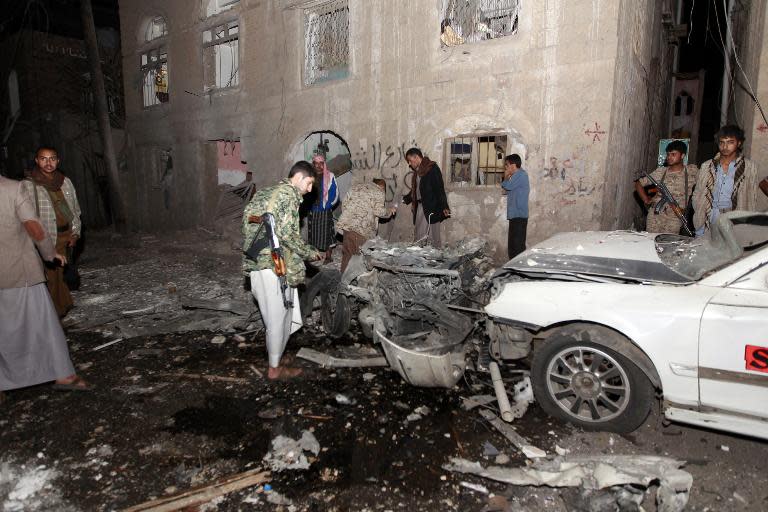 The wreckage of a car is seen at the site of a car bomb attack in the capital Sanaa on June 29, 2015