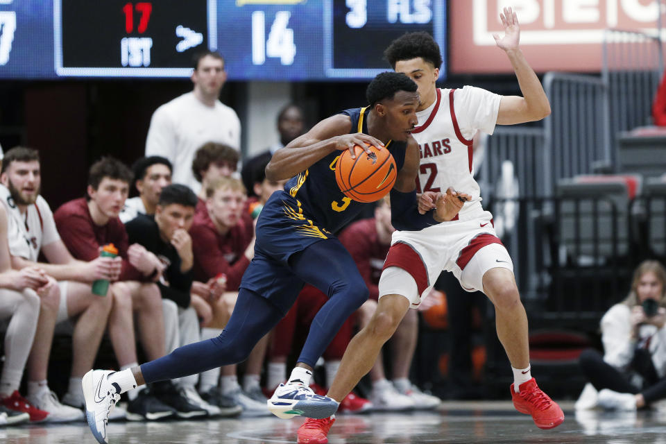 California guard Keonte Kennedy, left, drives while pressured by Washington State guard Isaiah Watts during the first half of an NCAA college basketball game Thursday, Feb. 15, 2024, in Pullman, Wash. (AP Photo/Young Kwak)