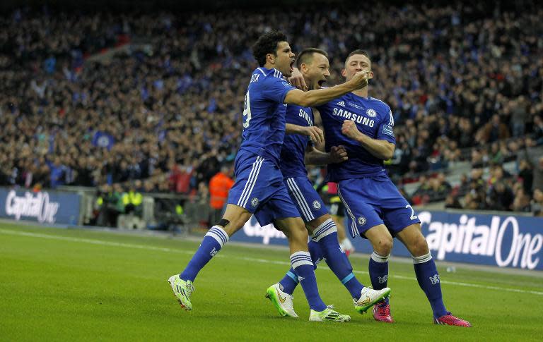 Chelsea's defender John Terry (2-L) celebrates scoring the opening goal with striker Diego Costa (L) and defender Gary Cahill during the English League Cup Final football match between Chelsea and Tottenham Hotspur on March 1, 2015 RESTRICTED TO EDITORIAL USE. No use with unauthorized audio, video, data, fixture lists, club/league logos or “live” services. Online in-match use limited to 45 images, no video emulation. No use in betting, games or single club/league/player publications