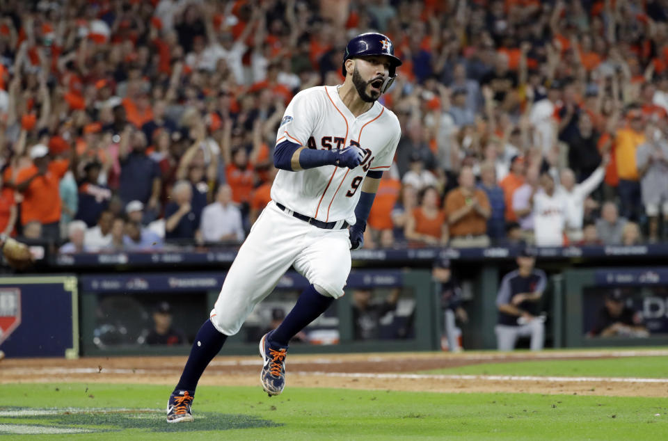 Houston Astros' Marwin Gonzalez (9) races to first base on a hit against the Cleveland Indians during the sixth inning of Game 2 of a baseball American League Division Series, Saturday, Oct. 6, 2018, in Houston. Two runs scored on the play. (AP Photo/David J. Phillip)