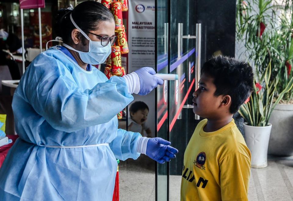 Medical personnel check the temperature of a visitor at the entrance of KPJ Tawakkal hospital in Kuala Lumpur, January 28, 2020. — Picture by Firdaus Latif