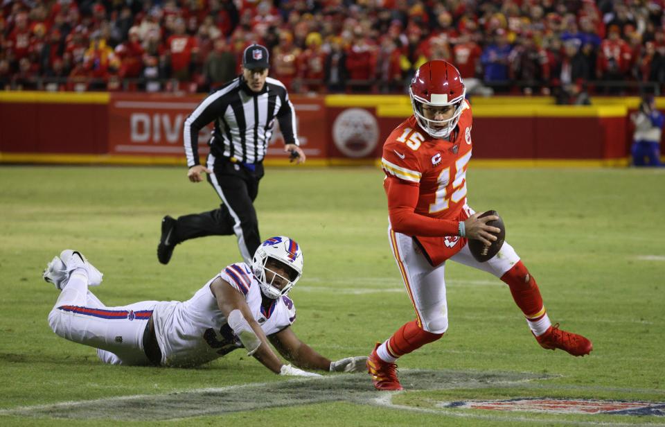 Chief quarterback Patrick Mahomes slips a tackle by Bills Ed Oliver. 