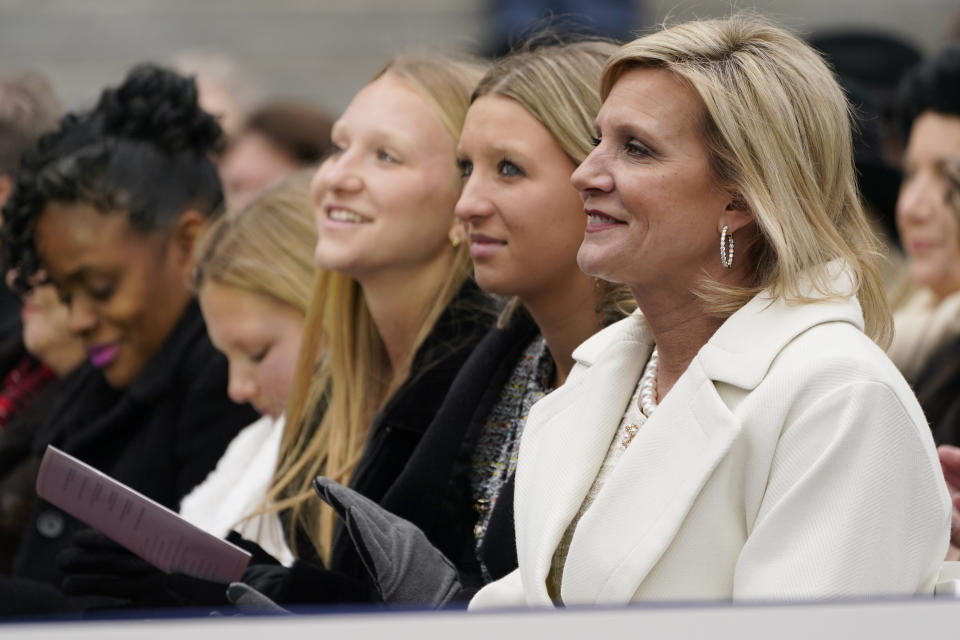 Mississippi First Lady Elee Reeves, right, and daughters Tyler, second from right, Emma, and Maddie, listen as their husband and father, Mississippi Gov. Tate Reeves delivers his address during his inauguration for a second term at the Mississippi State Capitol in Jackson, Miss., Tuesday, Jan. 9, 2024. (AP Photo/Rogelio V. Solis)