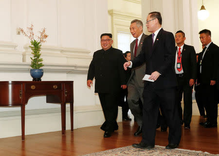 North Korea's leader Kim Jong Un walks with Singapore's Prime Minister Lee Hsien Loong at the Istana in Singapore June 10, 2018. REUTERS/Edgar Su